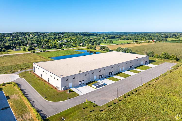 Aerial view of Highlands Business Park with industrial building, truck courts, and surrounding landscape.