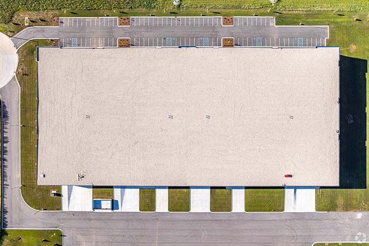 Top-down aerial of Highlands Business Park showing roof, truck docks, and parking layout.