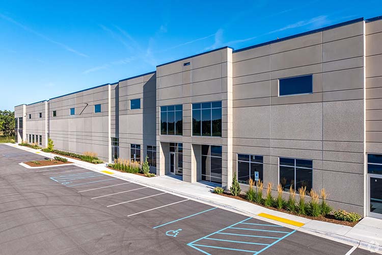 Modern office frontage and parking at Highlands Business Park.